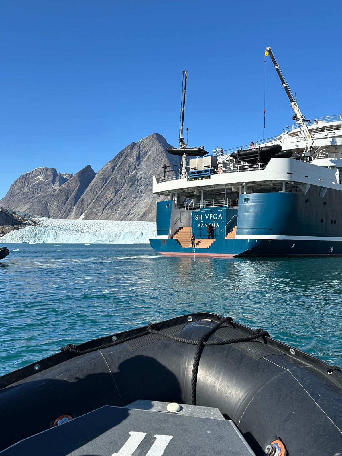 The SH Vega expedition ship anchors near a glacier with icebergs in Greenland's waters