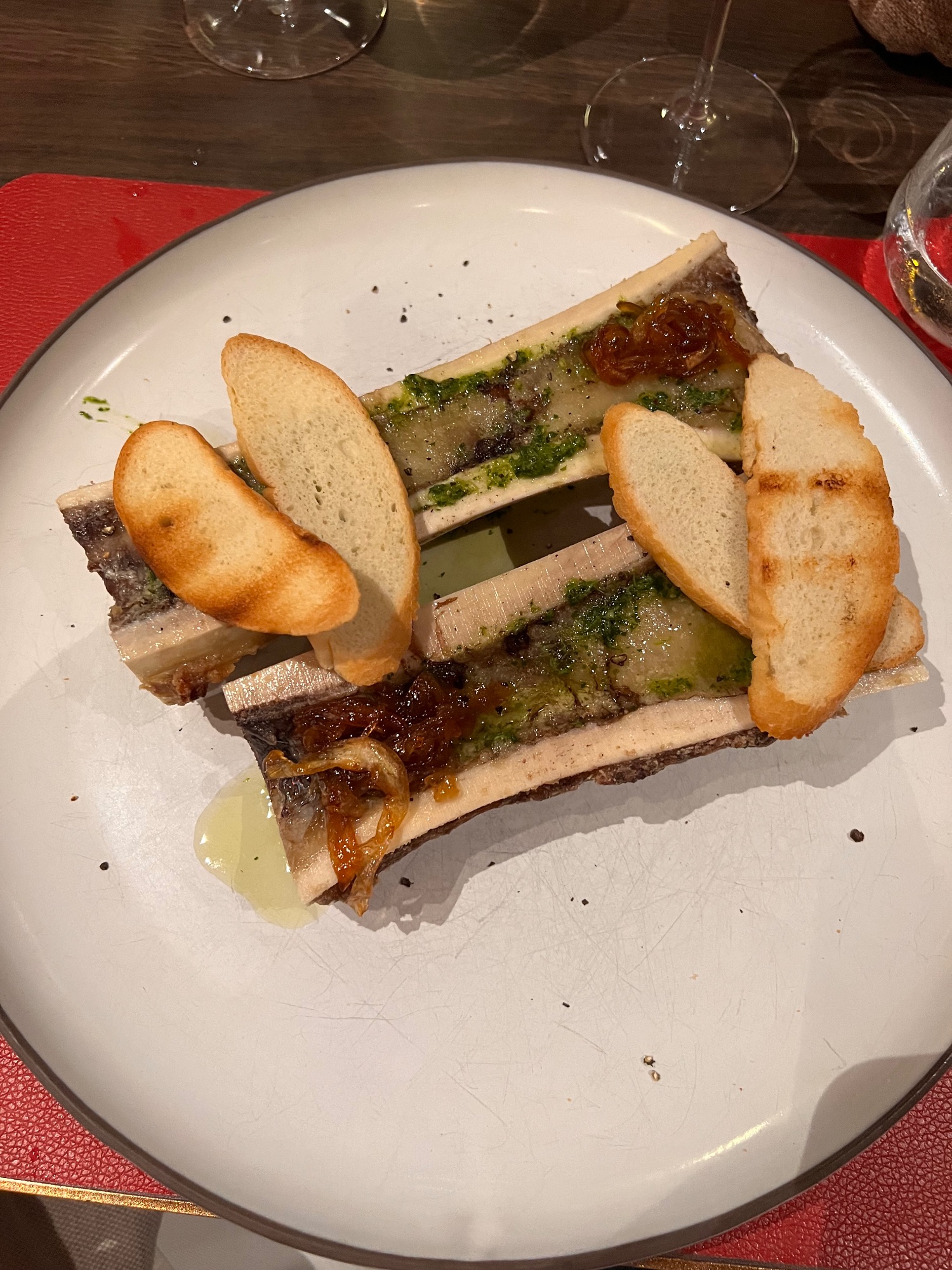 Foie gras terrine sandwich with toasted bread slices on a white plate at a fine dining restaurant