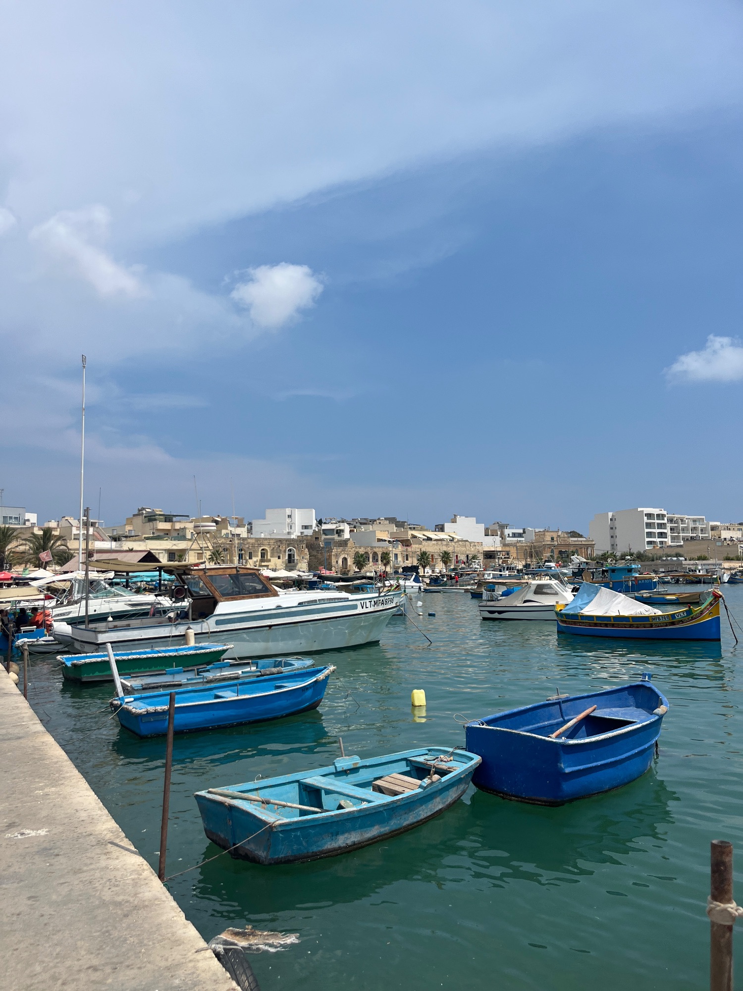 Panoramic view of Valletta harbor in Malta with historic fortifications, boats, and Mediterranean architecture