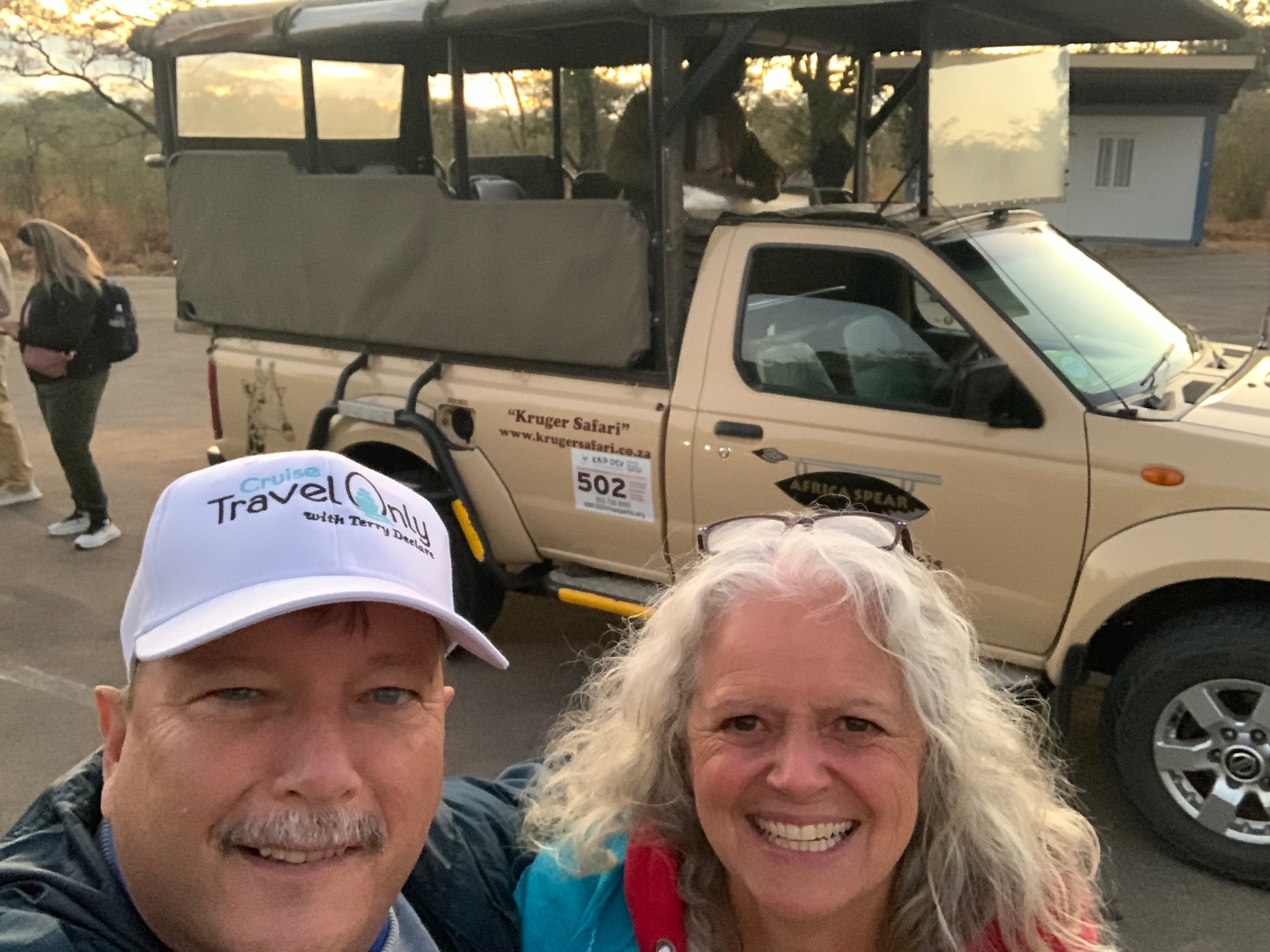 Safari vehicle numbered 502 parked at Kruger Park with guide and traveler in khaki landscape