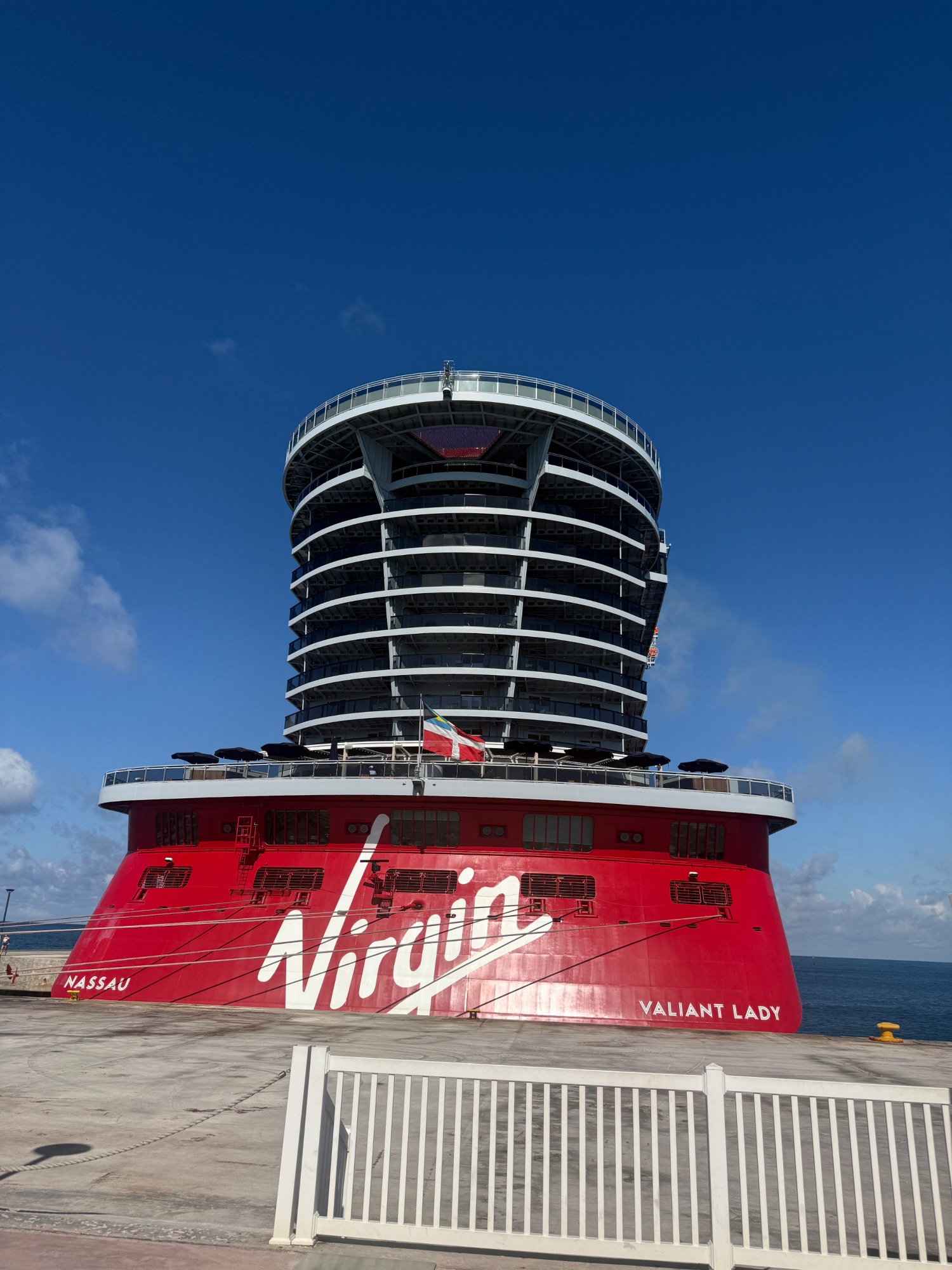 Virgin Valiant Lady cruise ship with distinctive red hull docked at Nassau port
