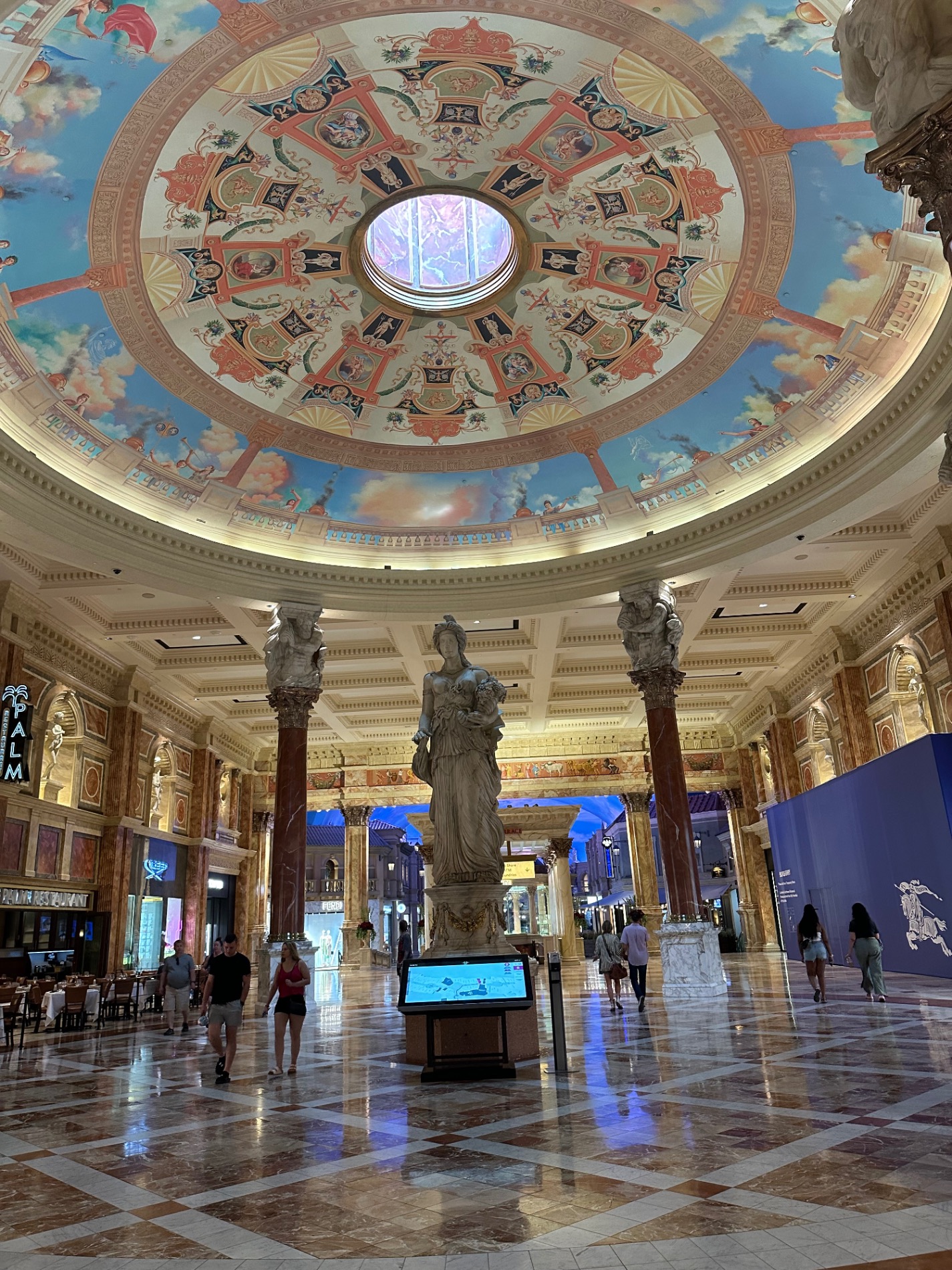 Luxor Hotel's Great Sphinx statue entrance with tourists walking toward illuminated interior passage