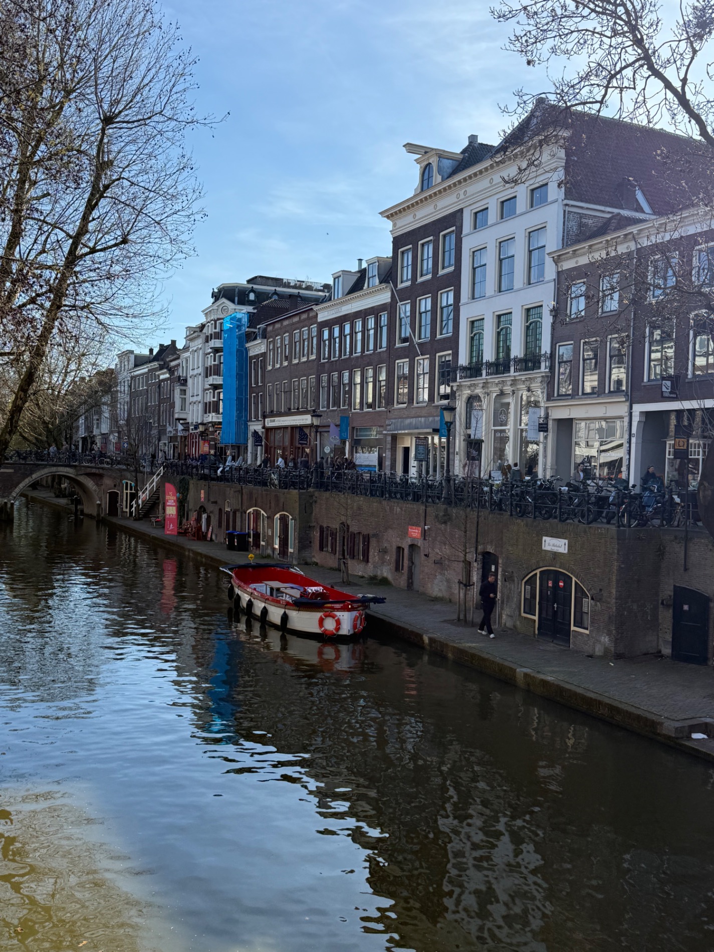 Whimsical stacked building with blue and green gabled roofs in Amsterdam waterfront area
