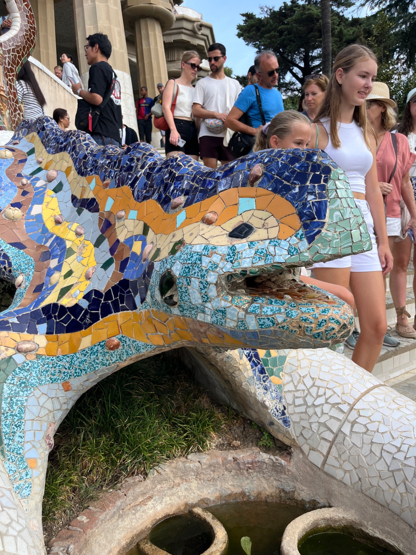 Gaudí's whimsical stone gatehouse at Park Güell with organic architecture and white mosaic details
