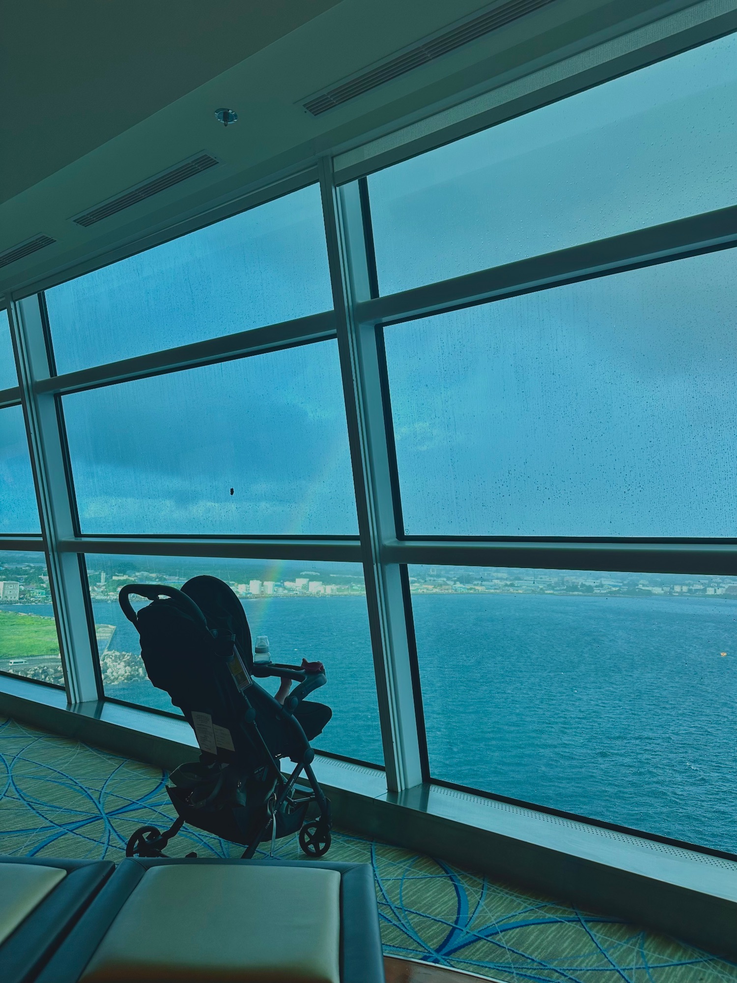Baby in a stroller on a cruise ship deck with a champagne glass in foreground