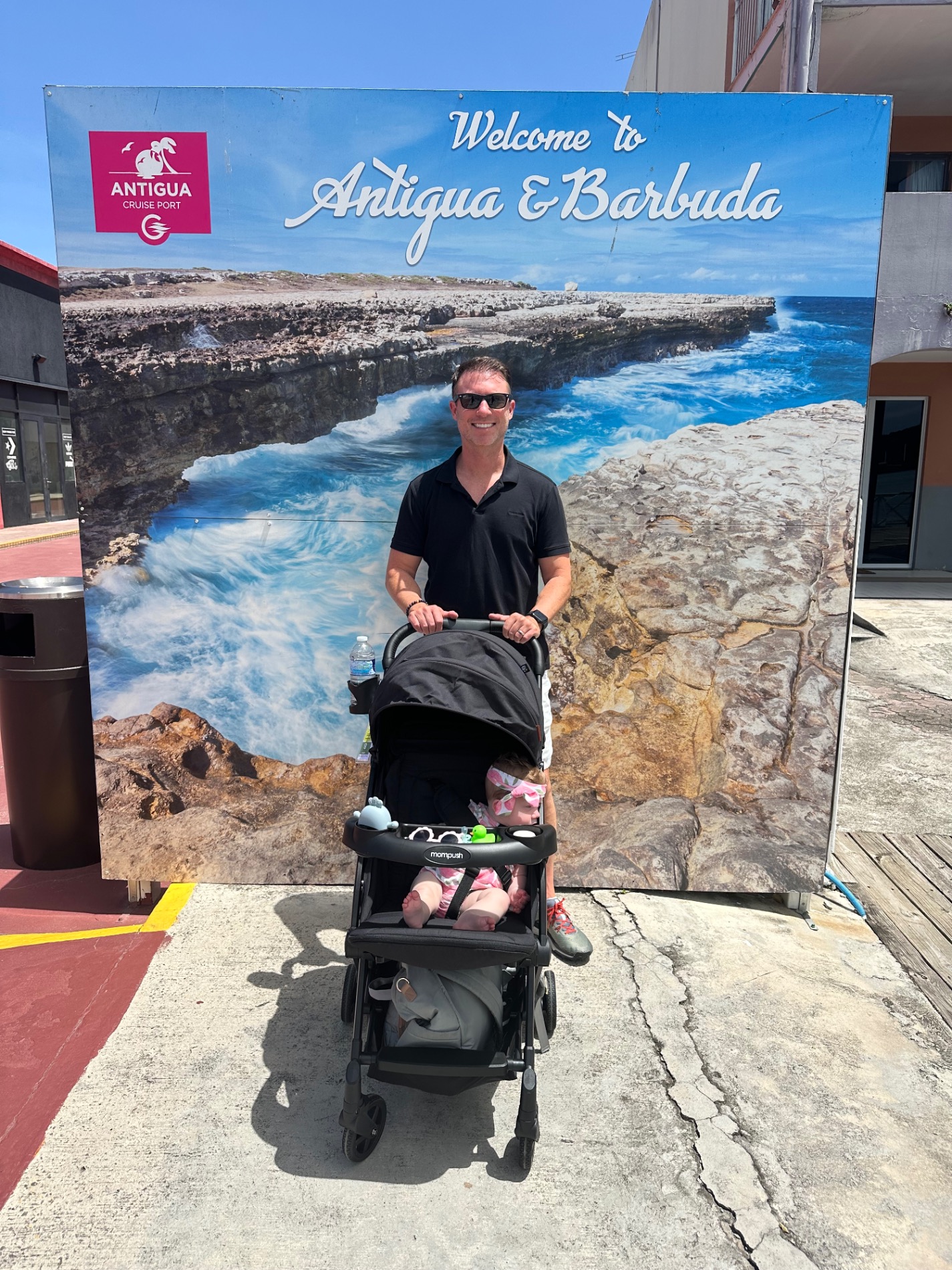 Man with a baby in a stroller at a cruise port in Antigua and Barbuda