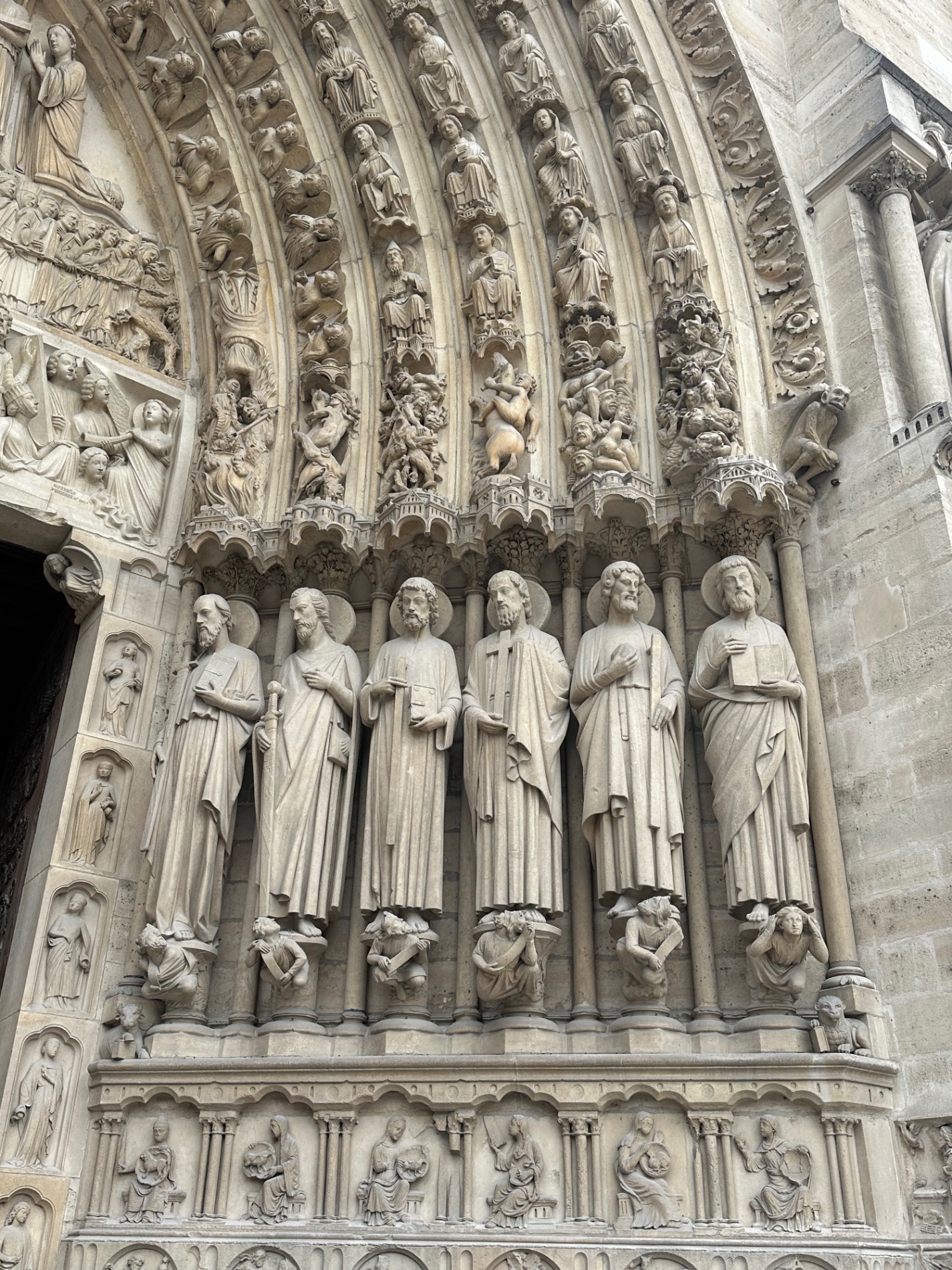 Ornate stone cathedral entrance with carved religious figures and intricate Gothic architectural details