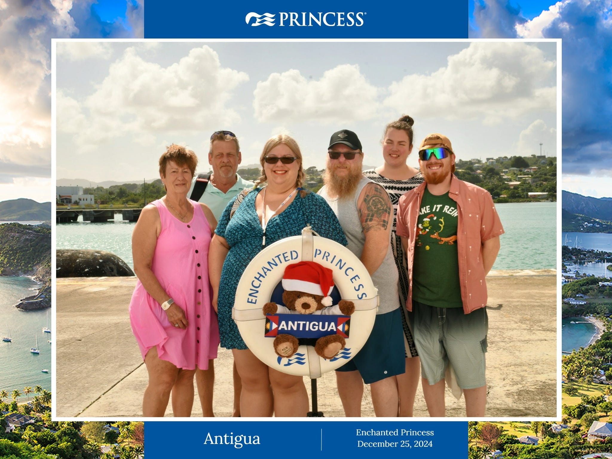 A family of six poses with an Enchanted Princess Antigua souvenir prop on Christmas Day.