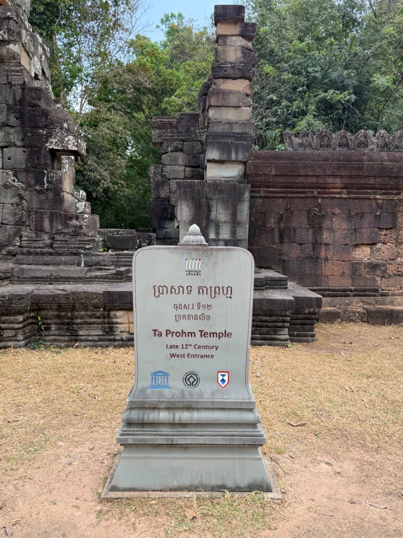 Sunrise over three distinctive temple towers at Angkor Wat with the sun positioned perfectly above the central spire