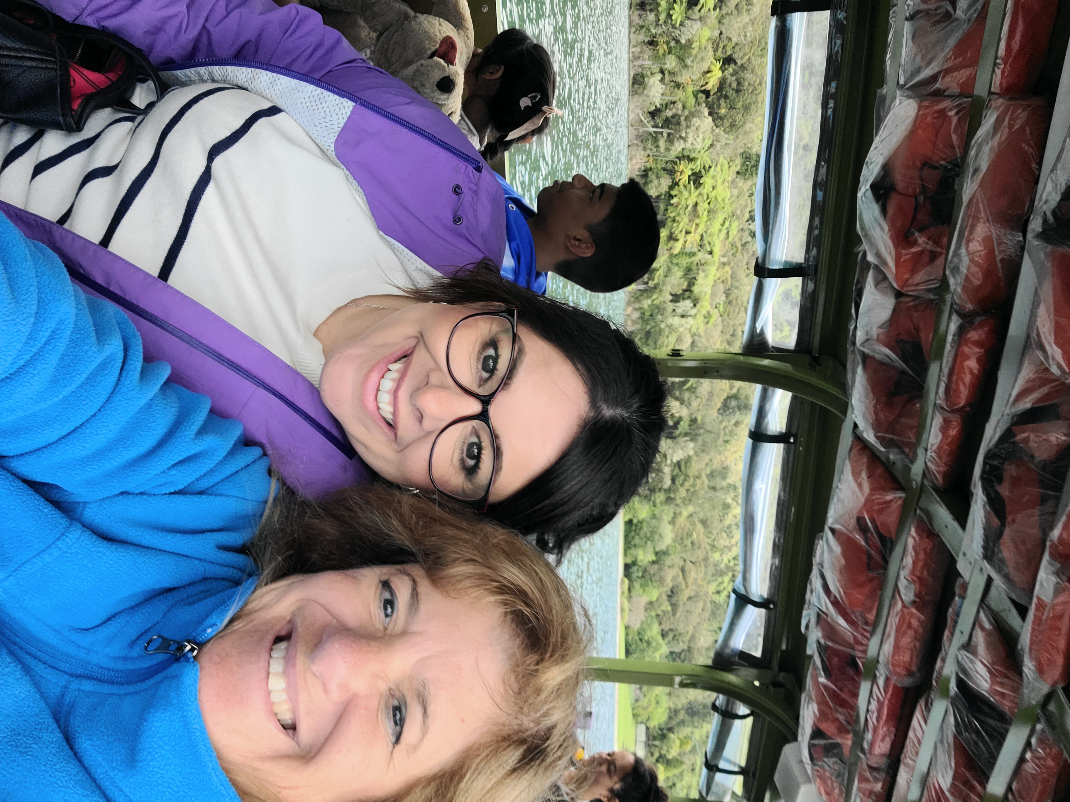 Deborah on a balcony overlooking a lake with volcanic island and mountains across the water