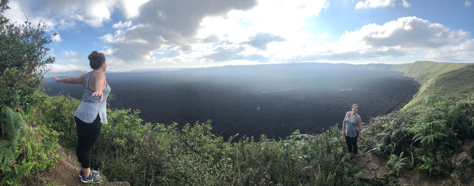 Beth Sharry at a scenic overlook above a vast volcanic crater landscape in the Galápagos