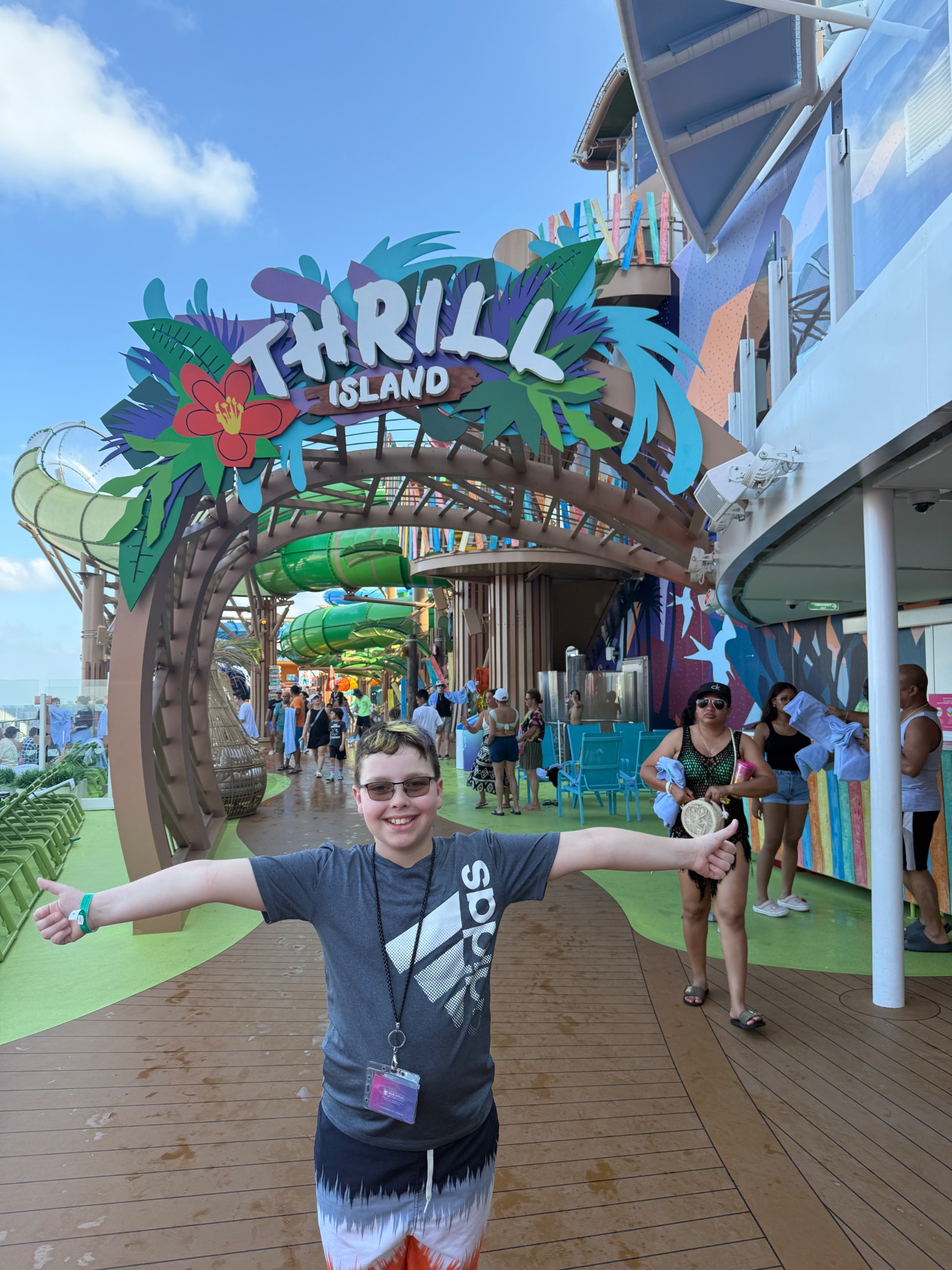 Young person playing mini golf at night on a ship with illuminated course and tropical theming