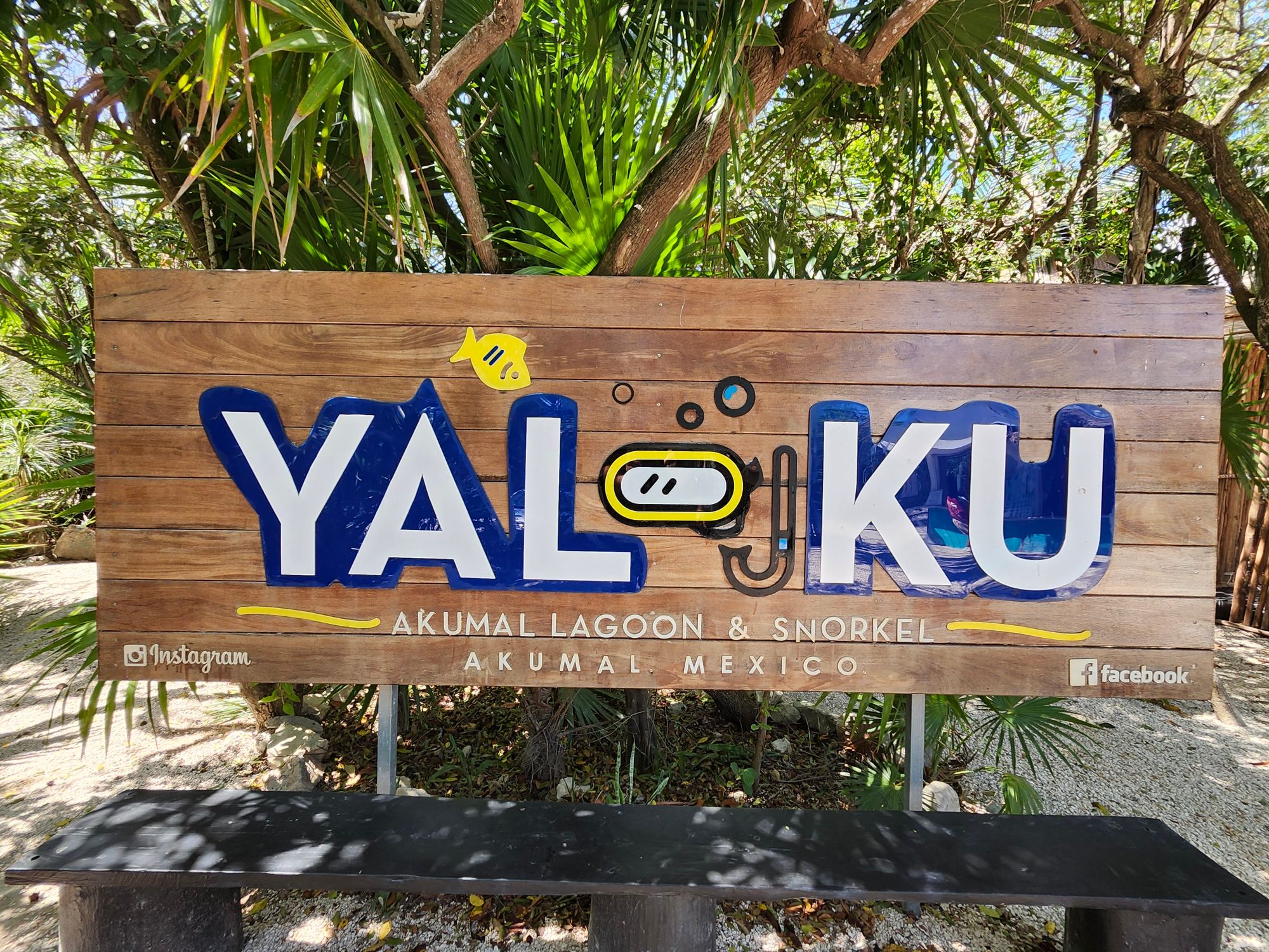 Yal-Ku Akumal Lagoon sign marking snorkel spot with tropical vegetation