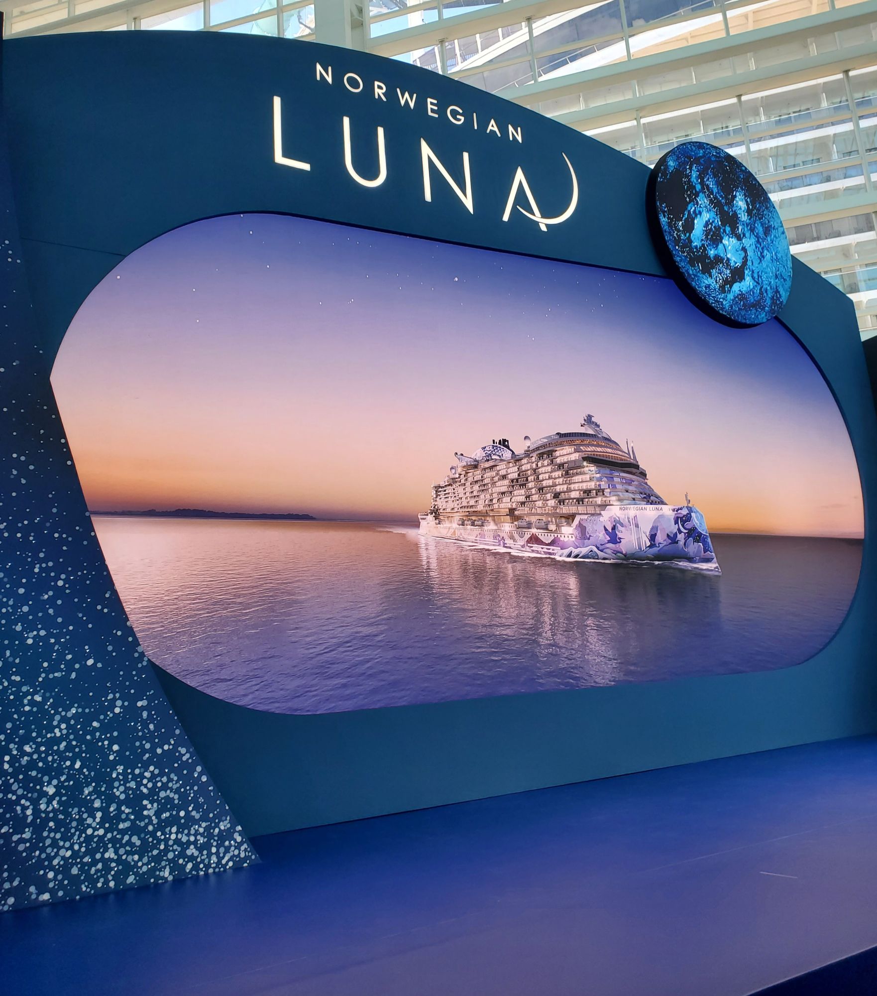 Norwegian Luna display sign with illuminated moon graphic in modern terminal interior
