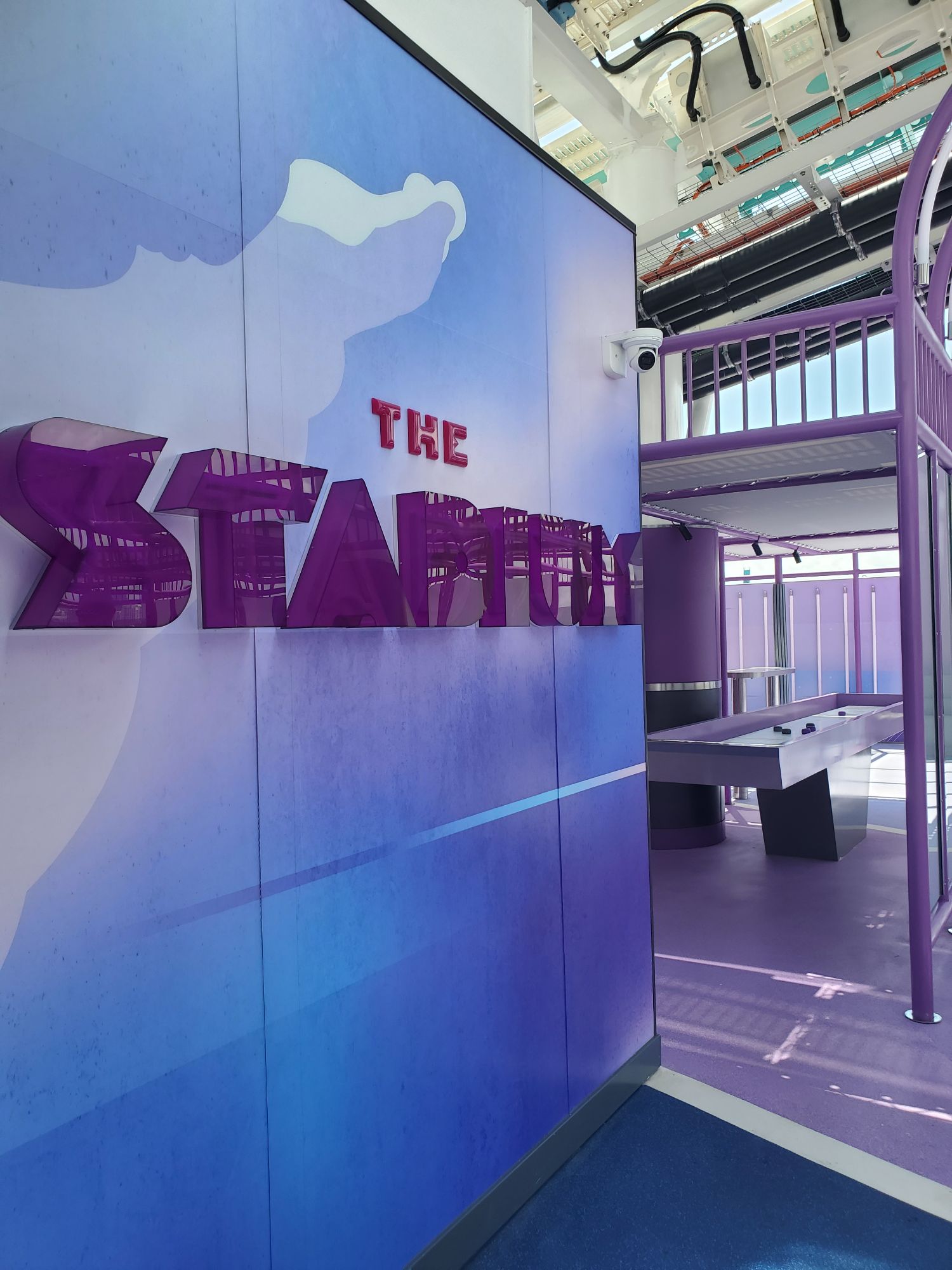 The Starry nightclub entrance with purple signage and modern interior design aboard Norwegian Luna