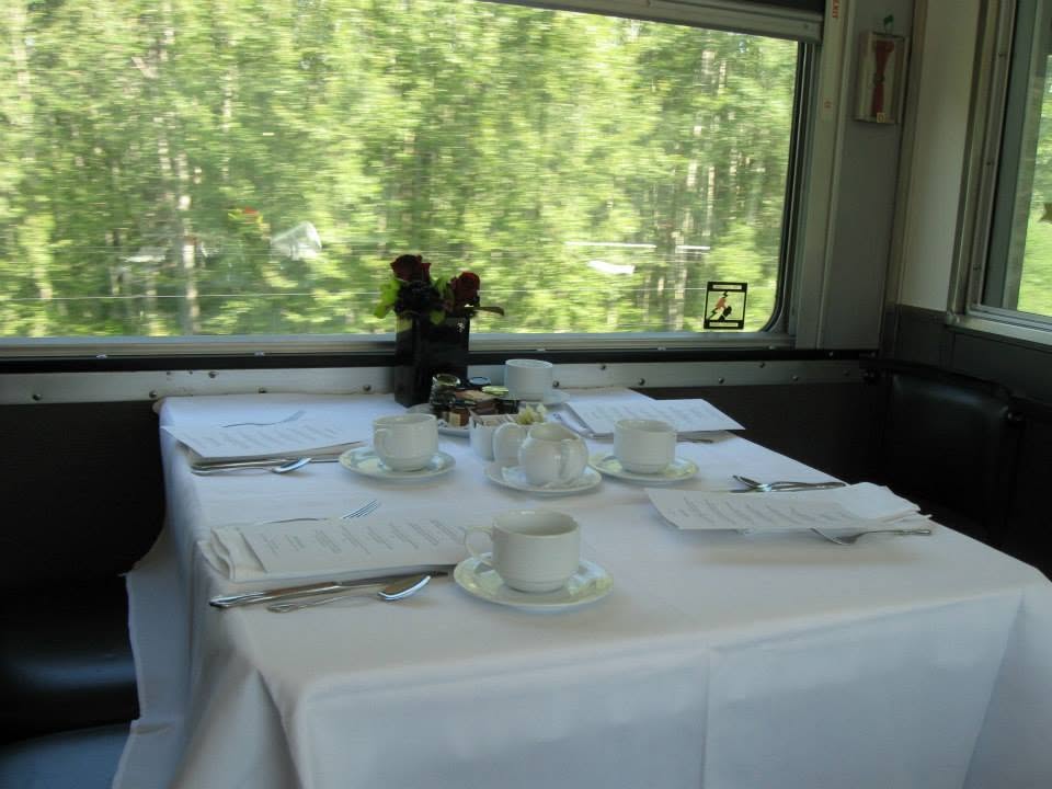 Interior of a dome car showing comfortable seating and expansive curved windows
