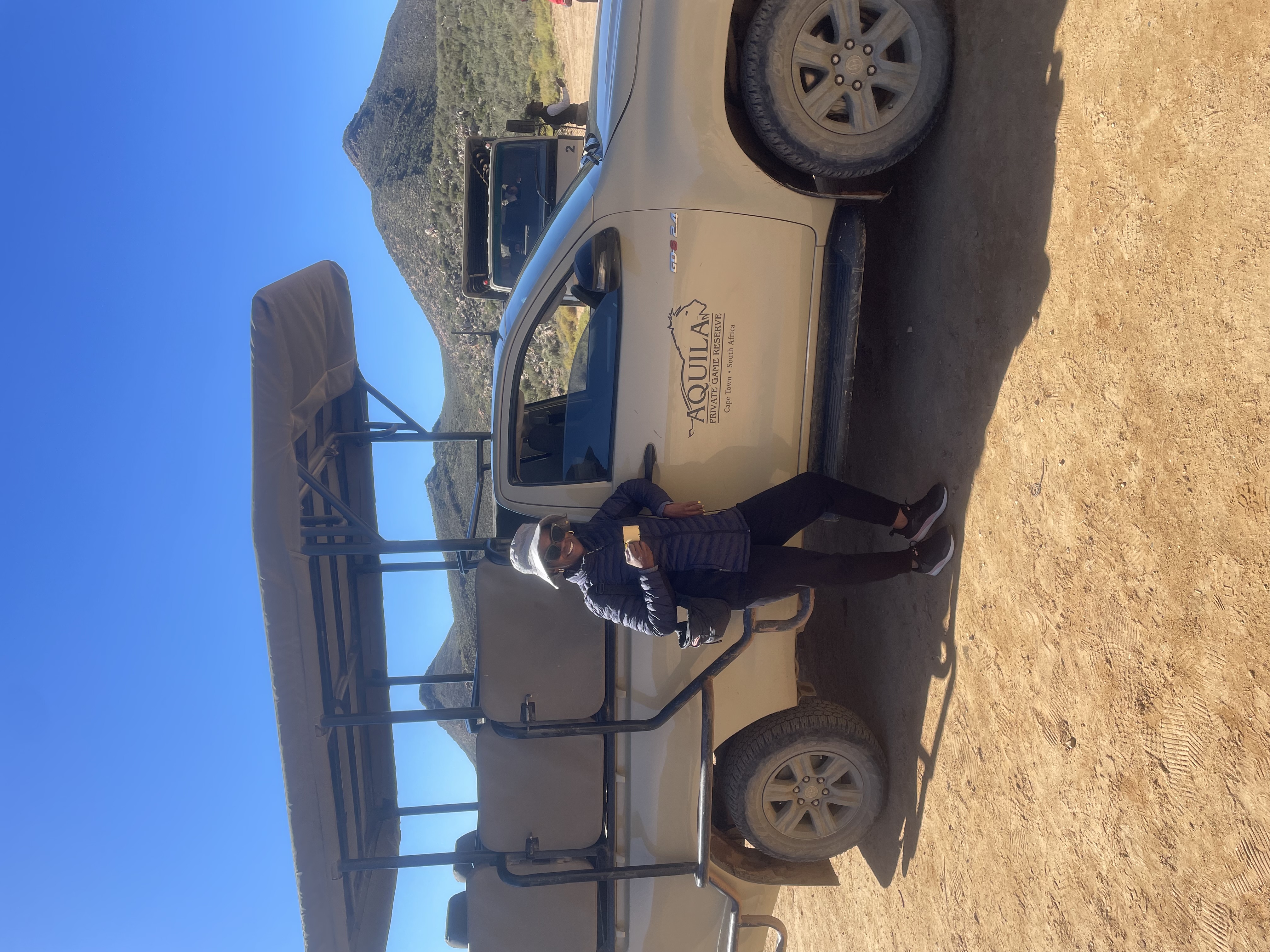 Roz riding a brown horse at what appears to be a game reserve in Cape Town
