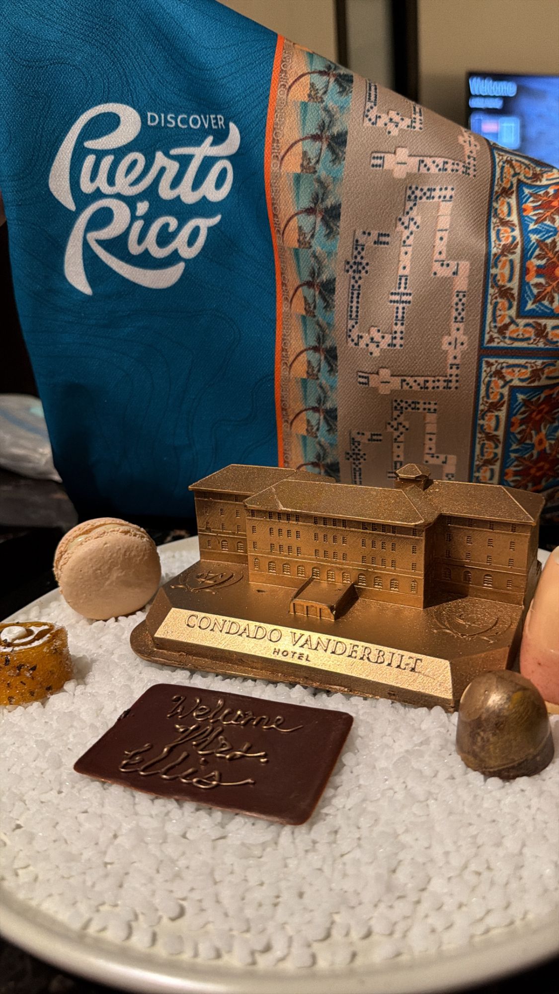 Condado Vanderbilt Hotel miniature model displayed with Puerto Rico tourism materials and chocolates