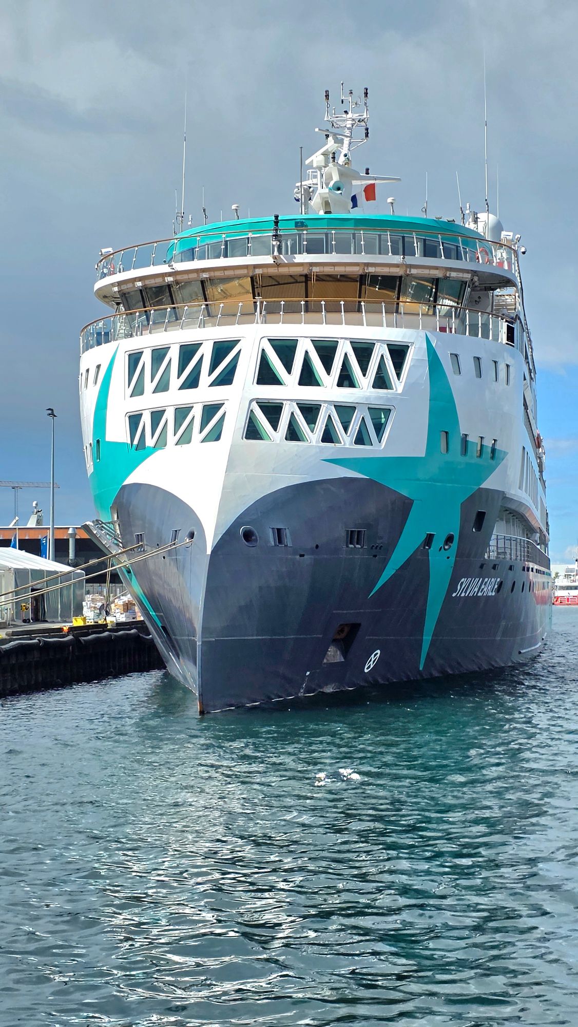 Cruise ship Silja Europa docked at port with turquoise and white hull design