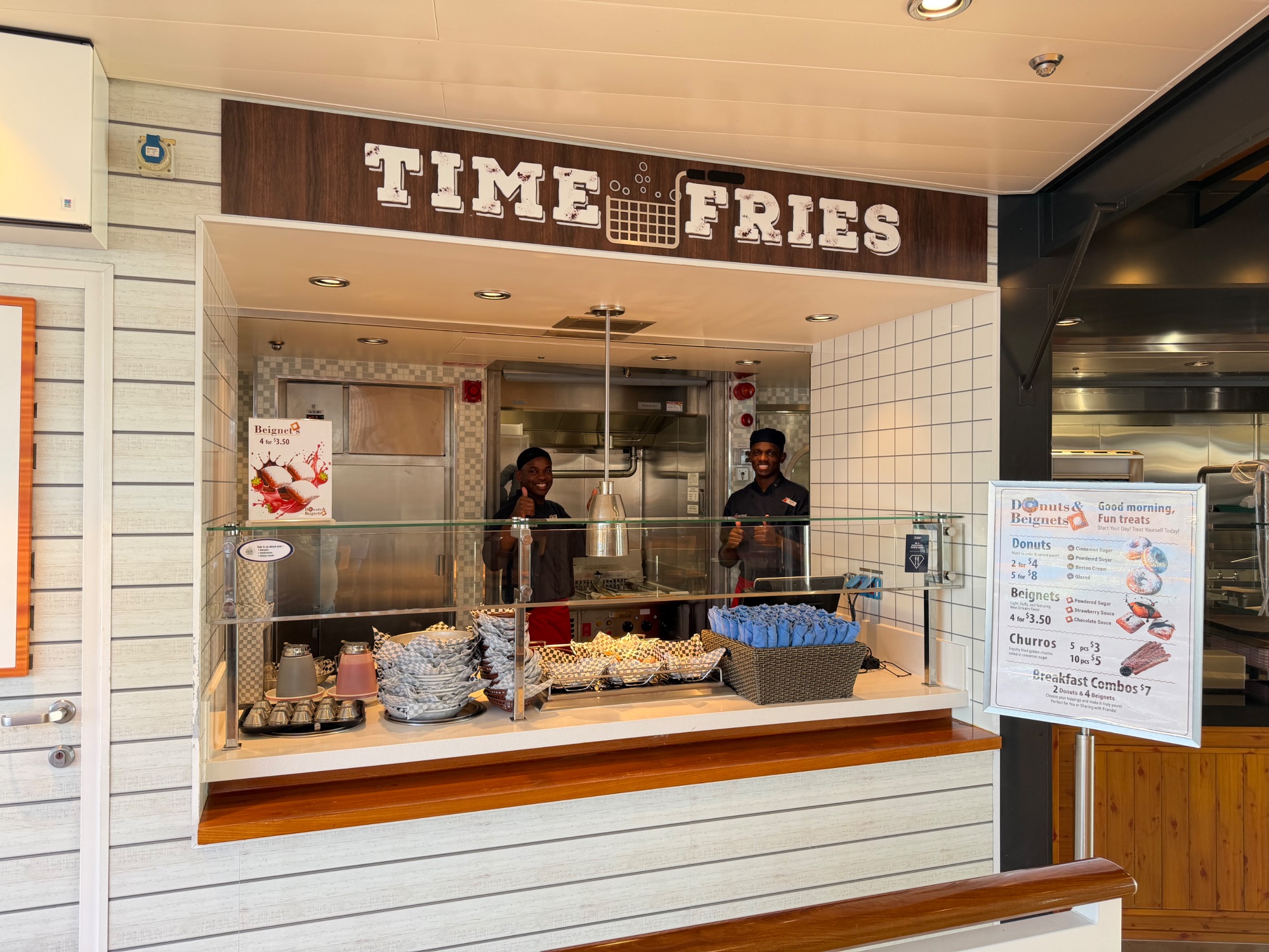 Time Fries food counter on a cruise ship with staff and pastries displayed